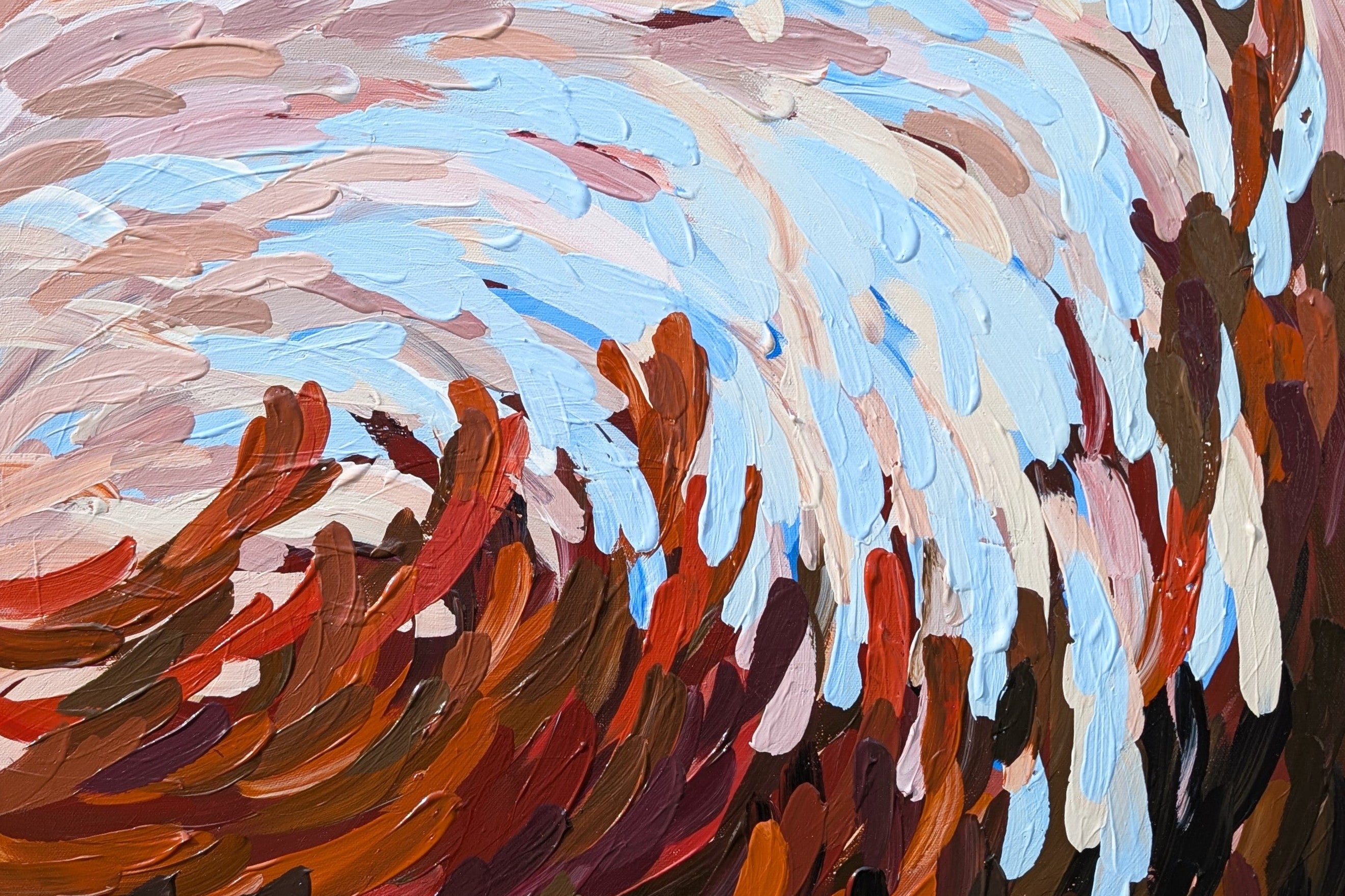 Abstract painting of a wave with swirling colors in a wooden frame.
